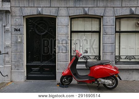 Amsterdam, Netherlands - July 10, 2017: Red Piaggio Vespa Scooter Parked In Amsterdam, Netherlands. 