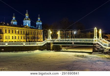 St. Nicholas Naval Cathedral And Night Illumination Of Red Guard Bridge On The Griboyedov Canal In W