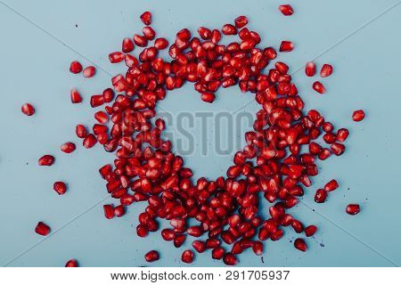 Garnet Background. Ripe Red Garnet Fruit. Garnet Fruit Slices On A Blue Background. Vegetarian Conce