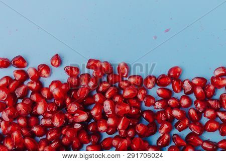 Garnet Background. Ripe Red Garnet Fruit. Garnet Fruit Slices On A Blue Background. Vegetarian Conce