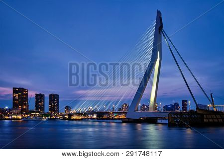 Erasmus Bridge (Erasmusbrug) and Rotterdam skyline illuminated at night. Rotterdam, Netherlands