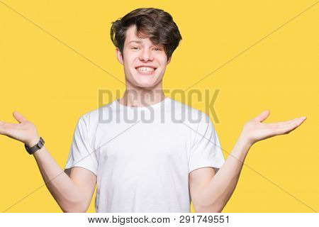 Young handsome man wearing casual white t-shirt over isolated background Smiling showing both hands open palms, presenting and advertising comparison and balance