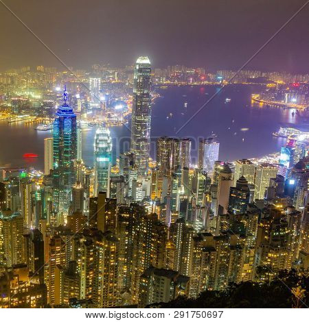 Hong Kong Skyline At Night As Seen From Victoria Peak. Illuminated Skyscrapers In Foreground, Hong K