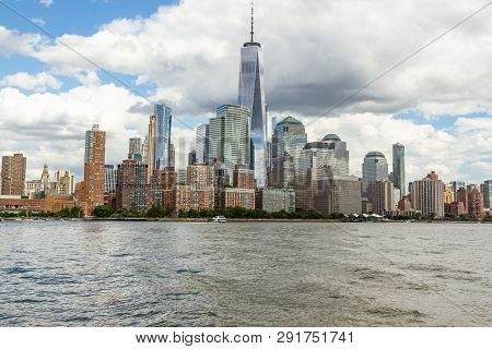 Manhattan Skyline In New York City As Seen From The Harbor. White Clouds In Blue Sky, Freedom Tower 