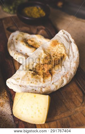 Cheese Patty On A Wooden Cutting Board