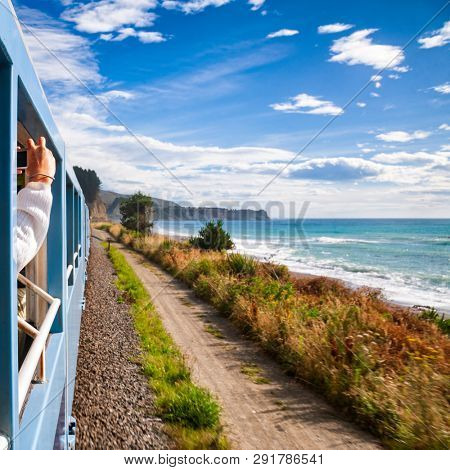Scenic train ride along Pacific ocean coast in Canterbury regoin, South Island of New Zealand