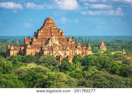 Bagan, Myanmar ancient temple ruins landscape with Dhammayangyi Temple in the archaeological zone at dusk. 