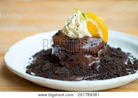 Chocolate Fondant And Orange Slice With Whip Cream Dcoration On Top