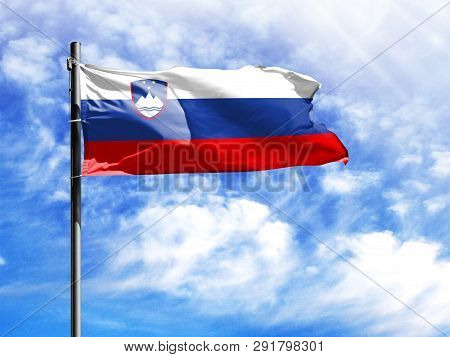 National Flag Of Slovenia On A Flagpole In Front Of Blue Sky.