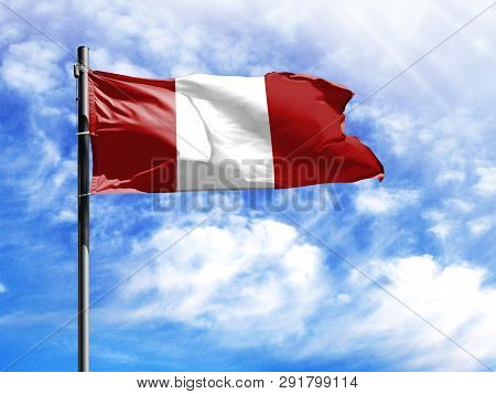 National Flag Of Peru On A Flagpole In Front Of Blue Sky.