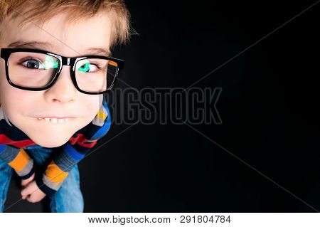 Funny Boy In Glasses, Looks At The Camera From The Bottom Up. Close-up. Copy Space