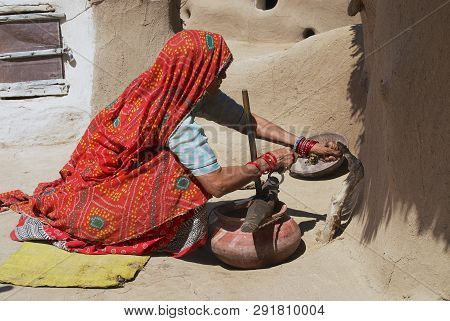 Jamba, India - April 02, 2007: Unidentified Senior Woman Wearing Traditional Dress Does Housework In