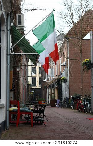 Arnhem, Netherlands - March 22, 2019: Ancient Street In The Center Of Arnhem With Terrace And Bicycl