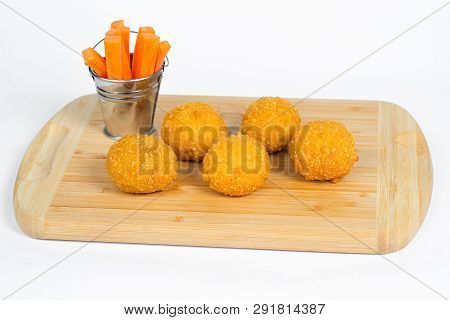 Breaded Chicken Ball On A Wooden Carrot
