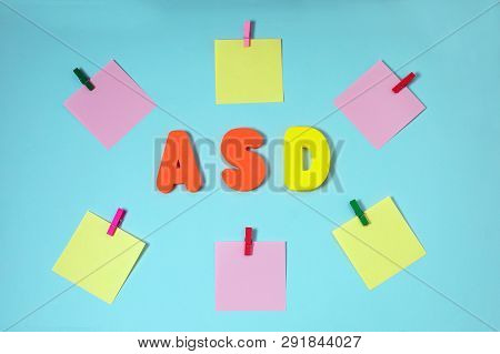 Asd. Autism Spectrum Disorder. Autism Concept With Color Paper Stickers On Blue Background. Top View