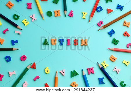 Autism Colorful Word From Color Wooden Letters On A Blue Background, World Autism Awareness Day, Apr