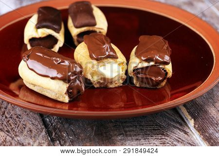 Traditional French Dessert. Eclair With Chocolate Icing. Pastery Concept With Chocolate Eclair