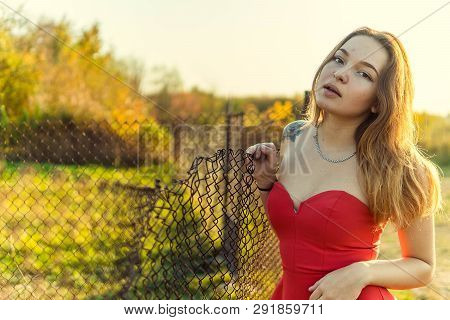A Woman Is Posing In Front Of A Camera In An Autumn Park. Autumn Photo Shoot. Autumn In The Park.
