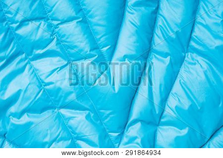 Close-up On Blue Puffer Jacket Texture. Background Of Quilted Material