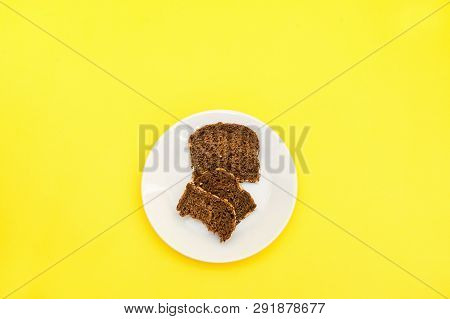 Sliced Rye Bread On The White Plare And Yelow Background. Whole Grain Rye Bread With Seeds
