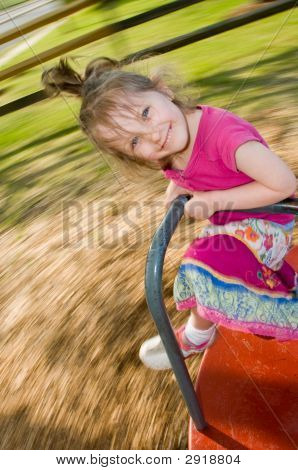 Girl Enjoys Merry-Go-Round Ride