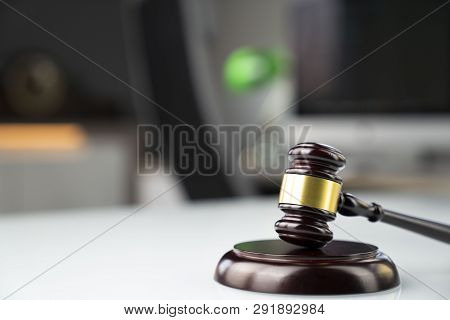 Lawyers Office. Gavel And Computer On The White Table.