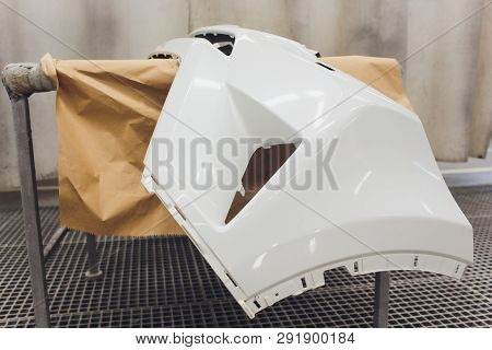 Repair Of The Rear Bumper Of A White Car After An Accident With The Help Of Multi-colored Putty In A