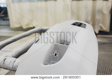 Repair Of The Rear Bumper Of A White Car After An Accident With The Help Of Multi-colored Putty In A