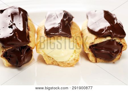 Traditional French Dessert. Eclair With Chocolate Icing. Pastery Concept With Chocolate Eclair