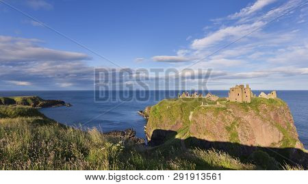 Landscape Of Dunnottar Castle Ruins Withh Dark Clouds And The Ocean