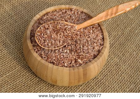 Uzbek Red Rice Devzira For Plov In A Bamboo Bowl On Burlap