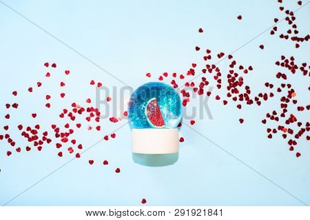 Beautiful Snow Ball With Watermelon And Glitter Inside On Pastel Blue Background Top View