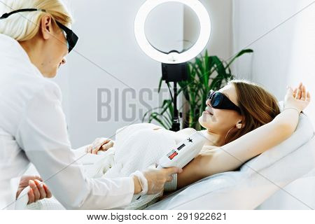 Body Care. Underarm Laser Hair Removal. Beautician Removing Hair Of Young Woman's Armpit. Laser Epil