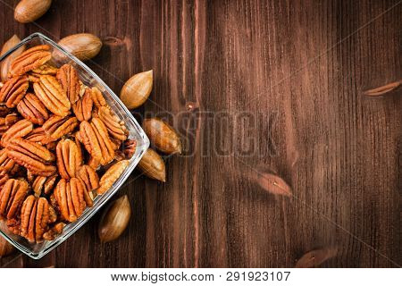 Pecan Nuts In The Shell With Pecan Kernel On Wooden Background