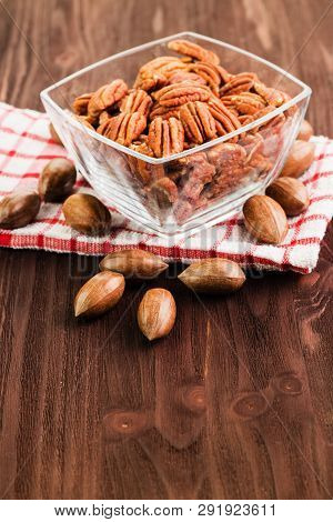 Pecan Nuts In The Shell With Pecan Kernel On Wooden Background