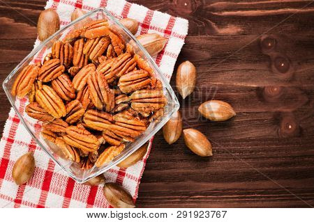 Pecan Nuts In The Shell With Pecan Kernel On Wooden Background