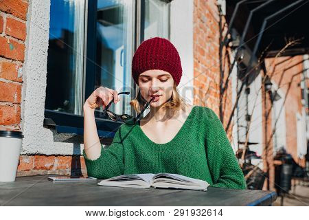 Young Female Sudent Learning In Coffee Shop Outdoor