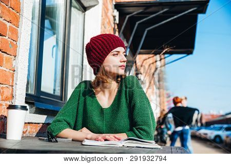 Young Female Sudent Learning In Coffee Shop Outdoor
