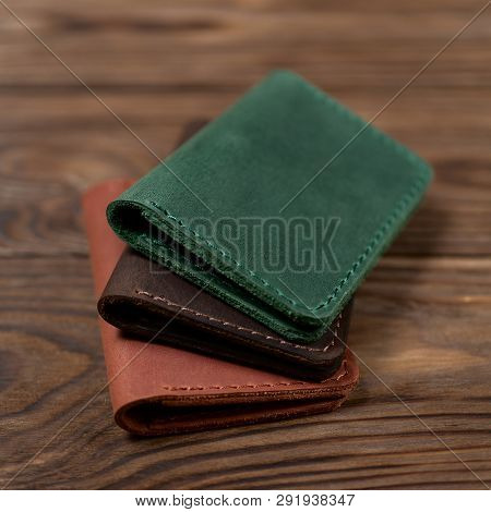 Three Two-pocket Leather Handmade Cardholder. Cardholders Lies One On Another. Stock Photo On Blurre