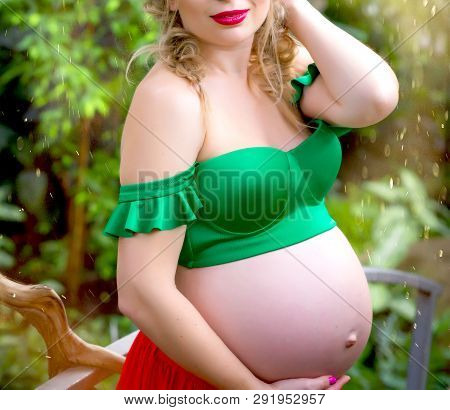 Beautiful Pregnant Girl Waiting For Baby In The Garden