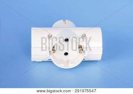 White Splitter For 220 Volt Electricity Grid On A Blue Background. Splitter For Simultaneous Switchi