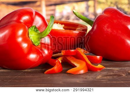 Group Of Two Whole One Half Four Slices Of Bulgarian Red Bell Pepper With Cart In Background
