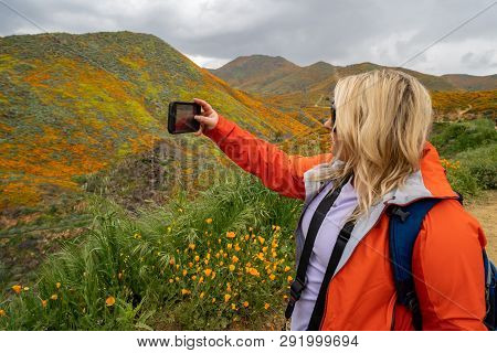 Blonde Woman Hiker Takes A Selfie With A Cell Phone While At Walker Canyon, Enjoying The California 