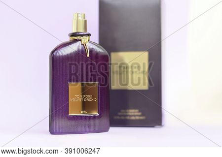 Tom Ford Velvet Orchid Fragrance Perfume Bottle Lies On Light Lilac Background. Tom Ford Is American