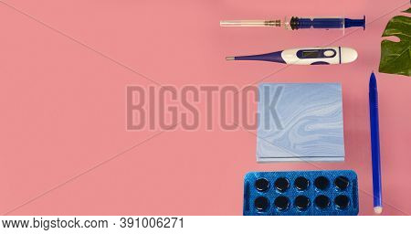 Flatlay Set Of Medical Instruments, Syringe, Thermometer, Notepad, Pen, Pills, Monstera Leaves On A 