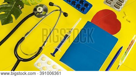 Flatlay Set Of Medical Instruments, Phonendoscope, Syringe, Thermometer, Notepad, Pen, Pills, Capsul
