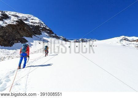 Rope Team Mountaineering With Crampons On Glacier Sexegertenferner Towards Sexegertenspitze And Moun