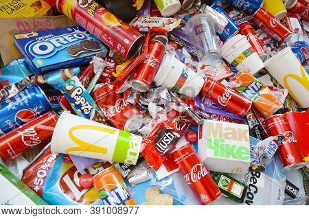 Many Wrappings And Cans From Used Products By Famous Worldwide Brands. Pattern Of Trash Of Various C