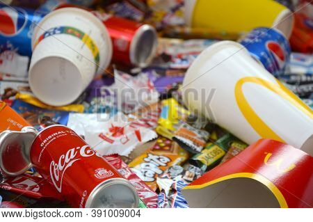 Many Wrappings And Cans From Used Products By Famous Worldwide Brands. Pattern Of Trash Of Various C