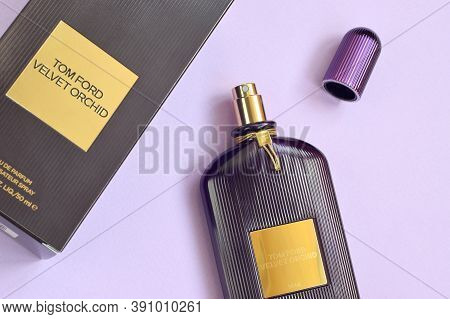 Tom Ford Velvet Orchid Fragrance Perfume Bottle Lies On Light Lilac Background. Tom Ford Is American